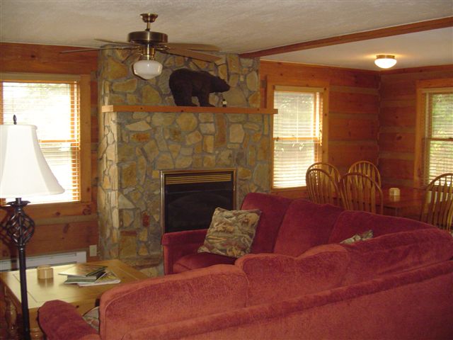 This Blowing Rock Cabin features a spacious den with stone fireplace.