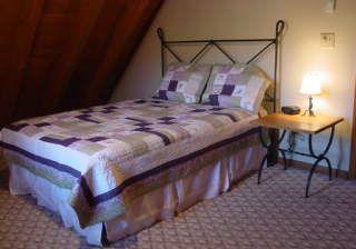 Queen bed in upstairs bedroom of blowing rock cabin